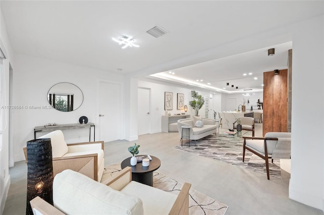 living room featuring a tray ceiling