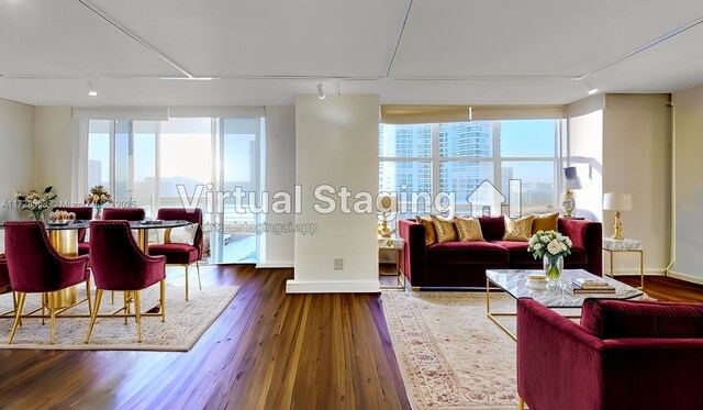 3600 Mystic Pointe Unit 1801, Aventura, FL 33180 - living room featuring rail lighting, wood finished floors, and baseboards