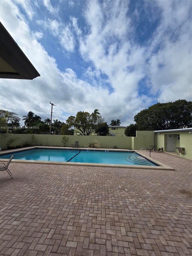 view of swimming pool with a patio area