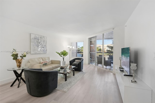 living room featuring floor to ceiling windows and hardwood / wood-style flooring