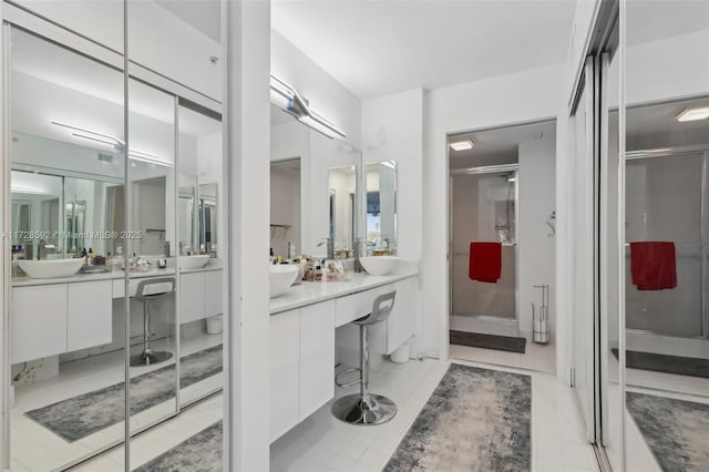 bathroom featuring tile patterned flooring, walk in shower, and vanity