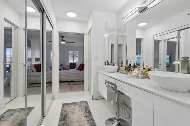 bathroom featuring ceiling fan, vanity, and tile patterned flooring