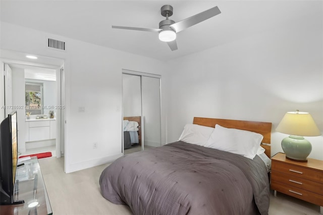 bedroom with ceiling fan, a closet, and light hardwood / wood-style floors