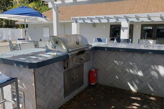 view of patio / terrace with grilling area, area for grilling, and a pergola