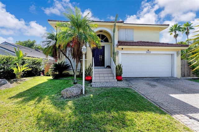 mediterranean / spanish house with a front yard and a garage