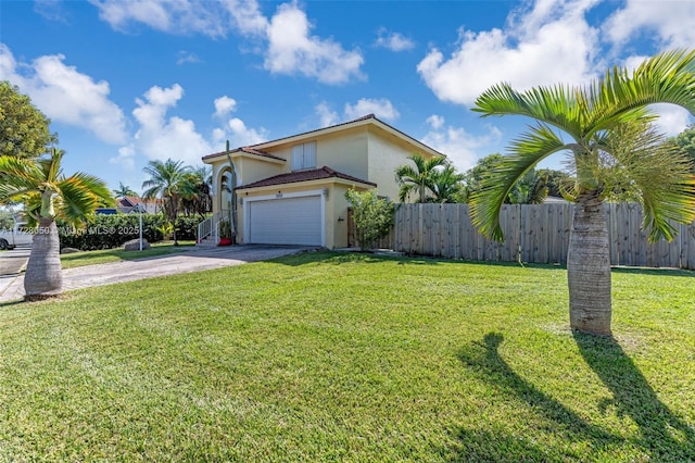 view of front of property with a front yard and a garage