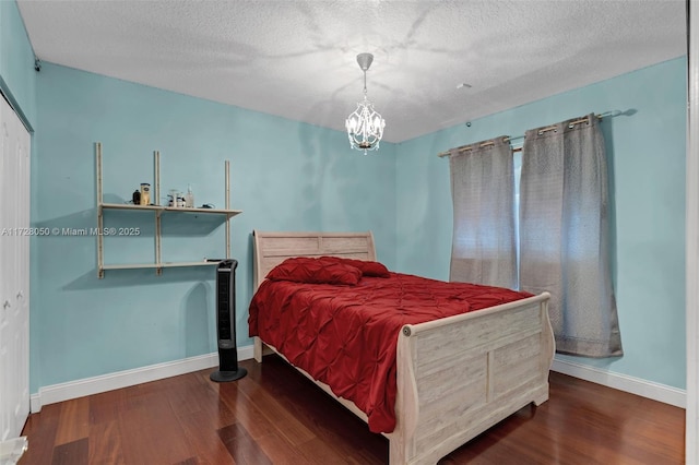 bedroom featuring hardwood / wood-style flooring and a textured ceiling