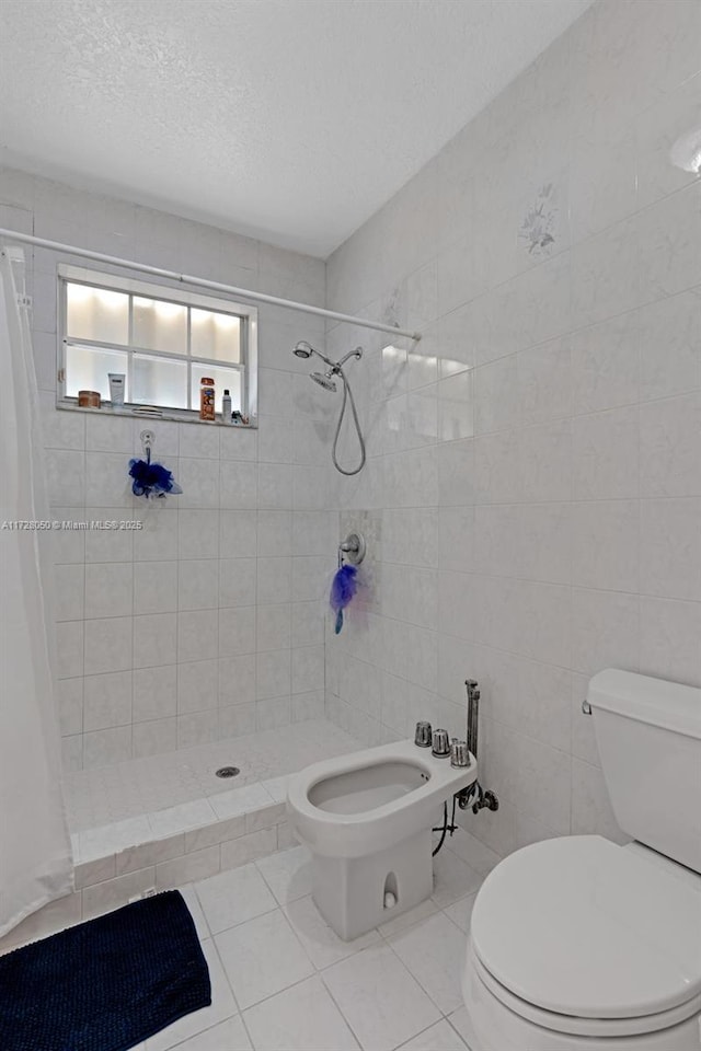 bathroom with walk in shower, tile walls, a bidet, and toilet