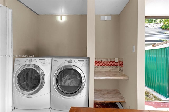 clothes washing area featuring independent washer and dryer