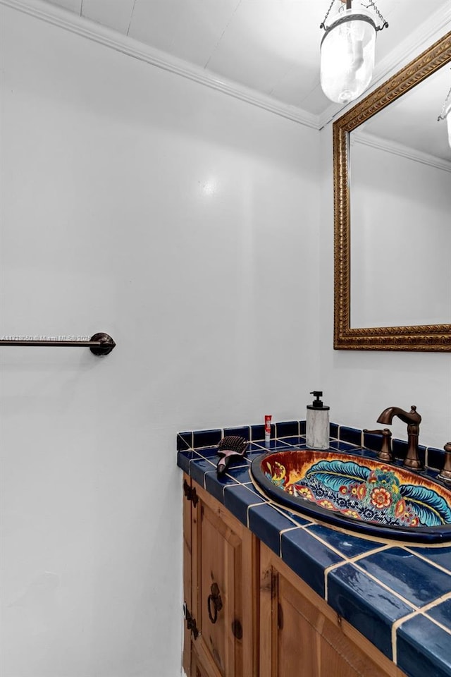 bathroom with ornamental molding and vanity