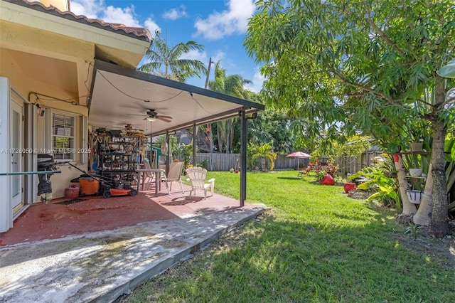 view of yard with a patio area and ceiling fan