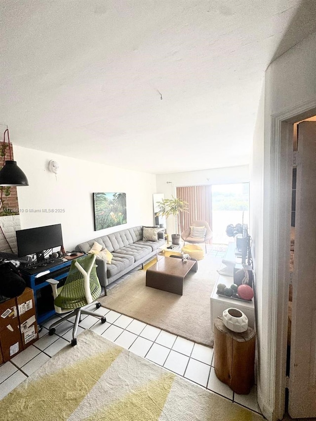 living room featuring light tile patterned floors and a textured ceiling