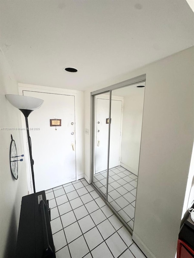 hallway with light tile patterned floors