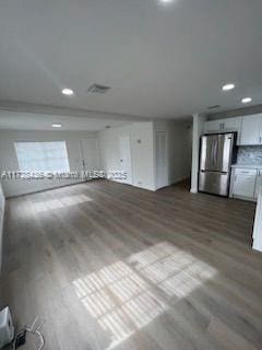 unfurnished living room with wood-type flooring