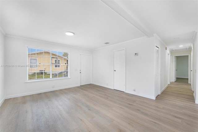 unfurnished living room with crown molding, baseboards, and light wood finished floors