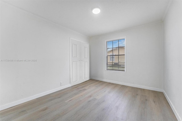 empty room featuring baseboards and wood finished floors