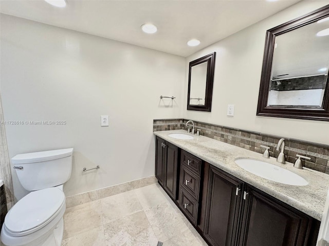 bathroom featuring toilet and vanity