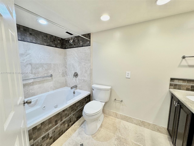 full bathroom with toilet, vanity, and tiled shower / bath