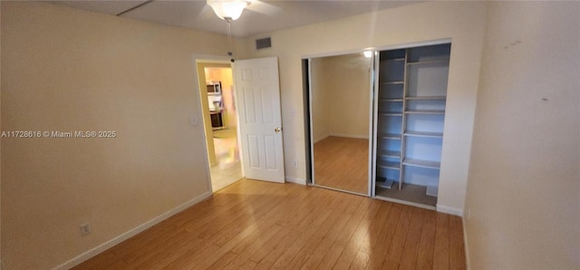 unfurnished bedroom featuring light wood-type flooring, a closet, and ceiling fan