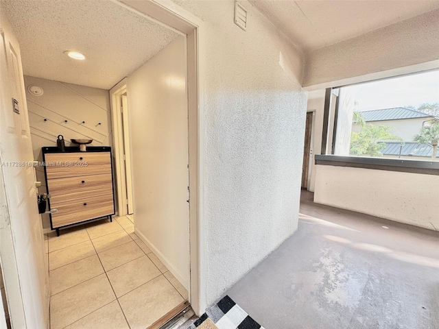 bathroom featuring a textured ceiling and tile patterned floors