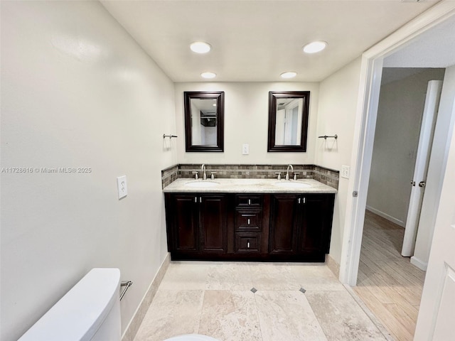 bathroom with toilet and vanity