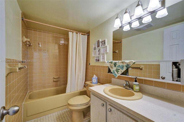 full bathroom featuring toilet, tile walls, tile patterned floors, shower / bath combination with curtain, and vanity