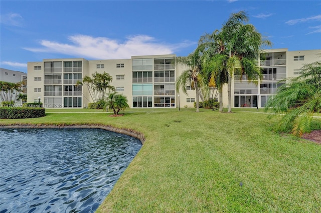 exterior space with a water view and a lawn