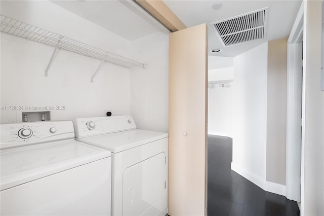 laundry room with dark hardwood / wood-style floors and independent washer and dryer