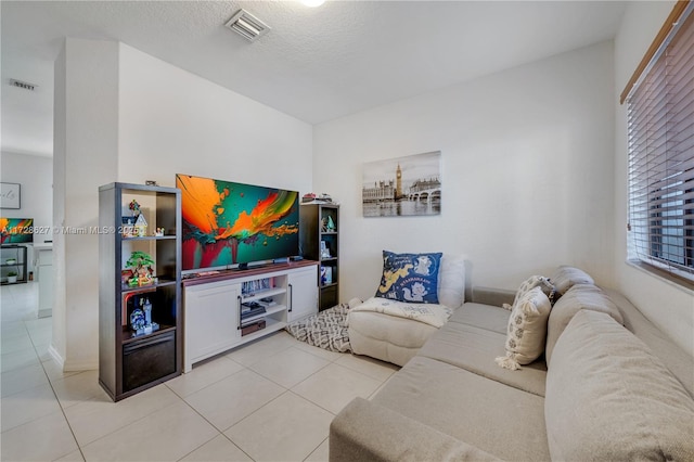 living room featuring light tile patterned floors and a textured ceiling