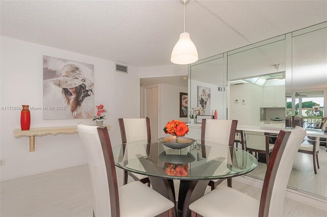 dining space with a textured ceiling