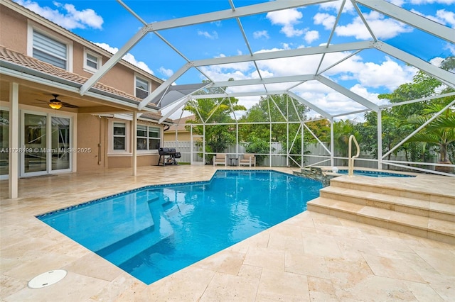 view of swimming pool with area for grilling, an in ground hot tub, a lanai, ceiling fan, and a patio area