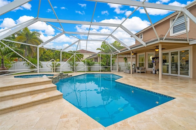 view of pool featuring an in ground hot tub, ceiling fan, a lanai, and a patio