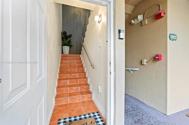 stairway with tile patterned flooring