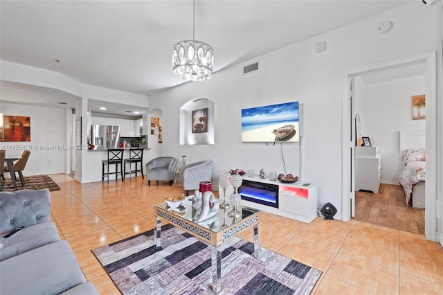 living room featuring light tile patterned floors and a notable chandelier