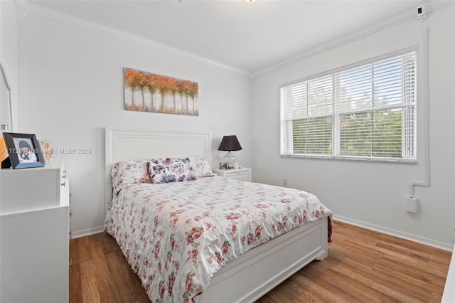 bedroom featuring wood-type flooring and crown molding