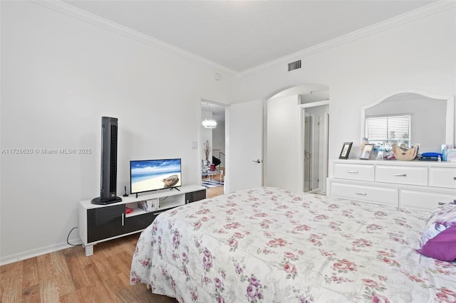 bedroom with ornamental molding and light hardwood / wood-style flooring