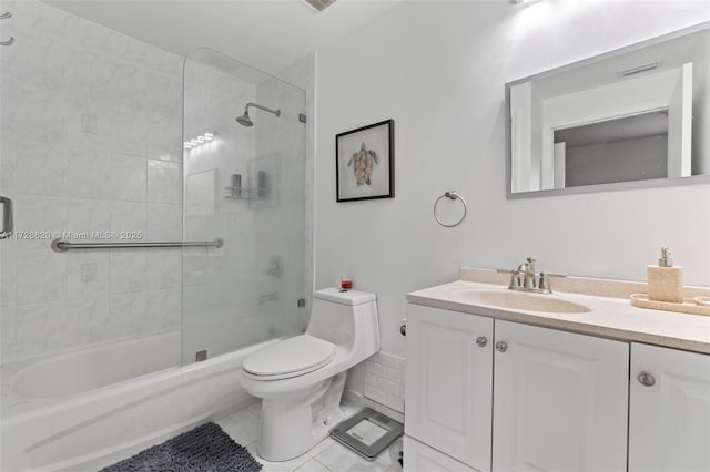 full bathroom with bath / shower combo with glass door, toilet, and vanity