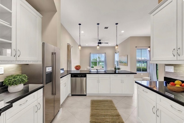 kitchen featuring decorative light fixtures, white cabinets, plenty of natural light, and stainless steel appliances