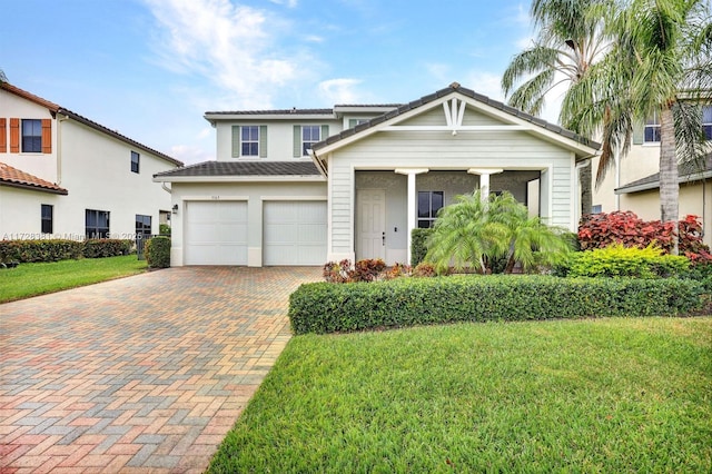 view of front of house with a front lawn and a garage