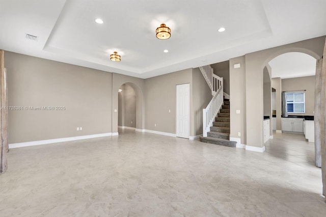 empty room featuring a raised ceiling