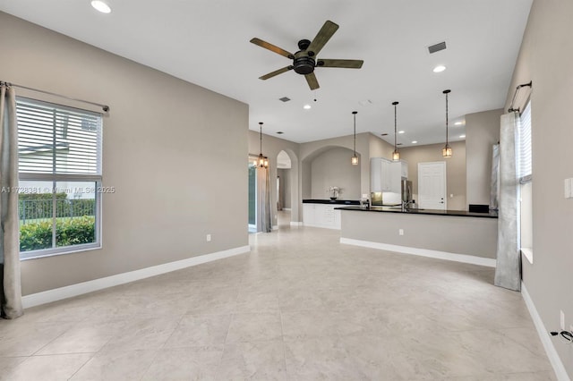 interior space with ceiling fan