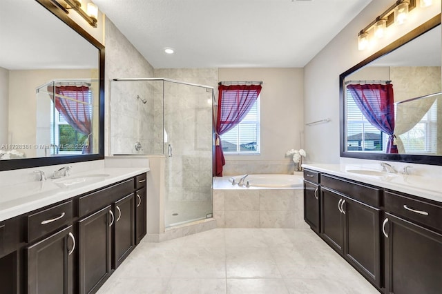 bathroom with tile patterned floors, vanity, and separate shower and tub