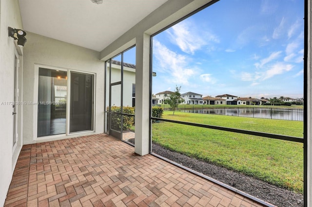 unfurnished sunroom with a water view