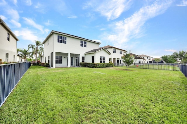 rear view of house with a lawn