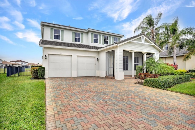 view of front of house featuring a front yard and a garage