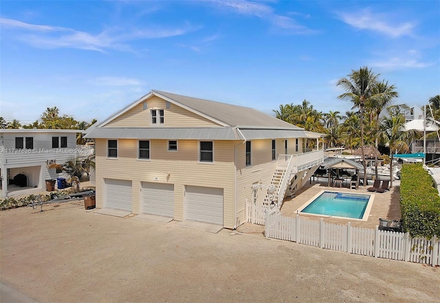 view of pool featuring stairway, fence, and a fenced in pool