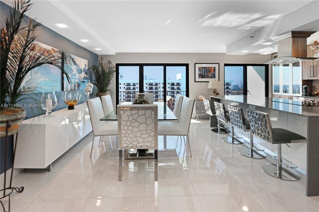 tiled living room with a notable chandelier