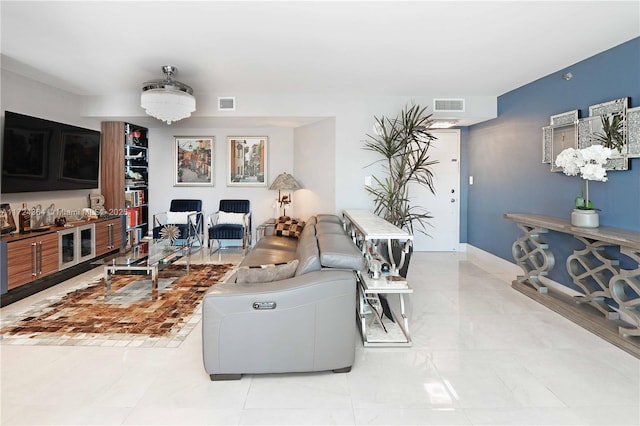 living room with baseboards and visible vents