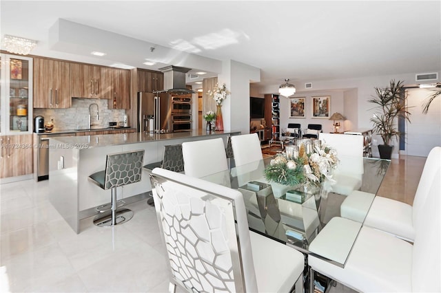 dining room featuring light tile patterned flooring and visible vents