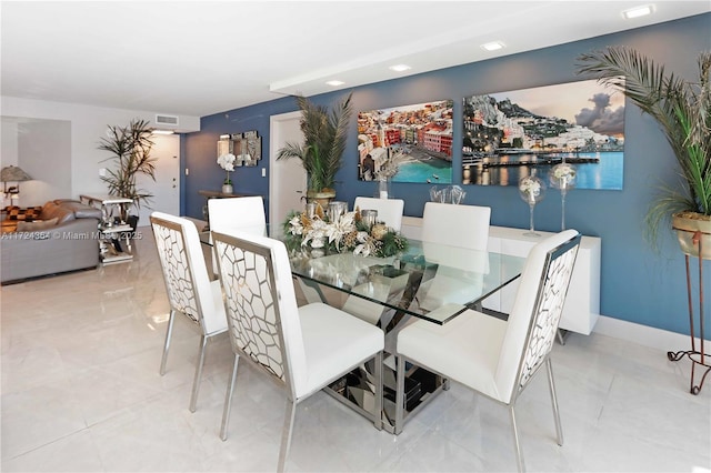 dining area featuring tile patterned floors, visible vents, and baseboards